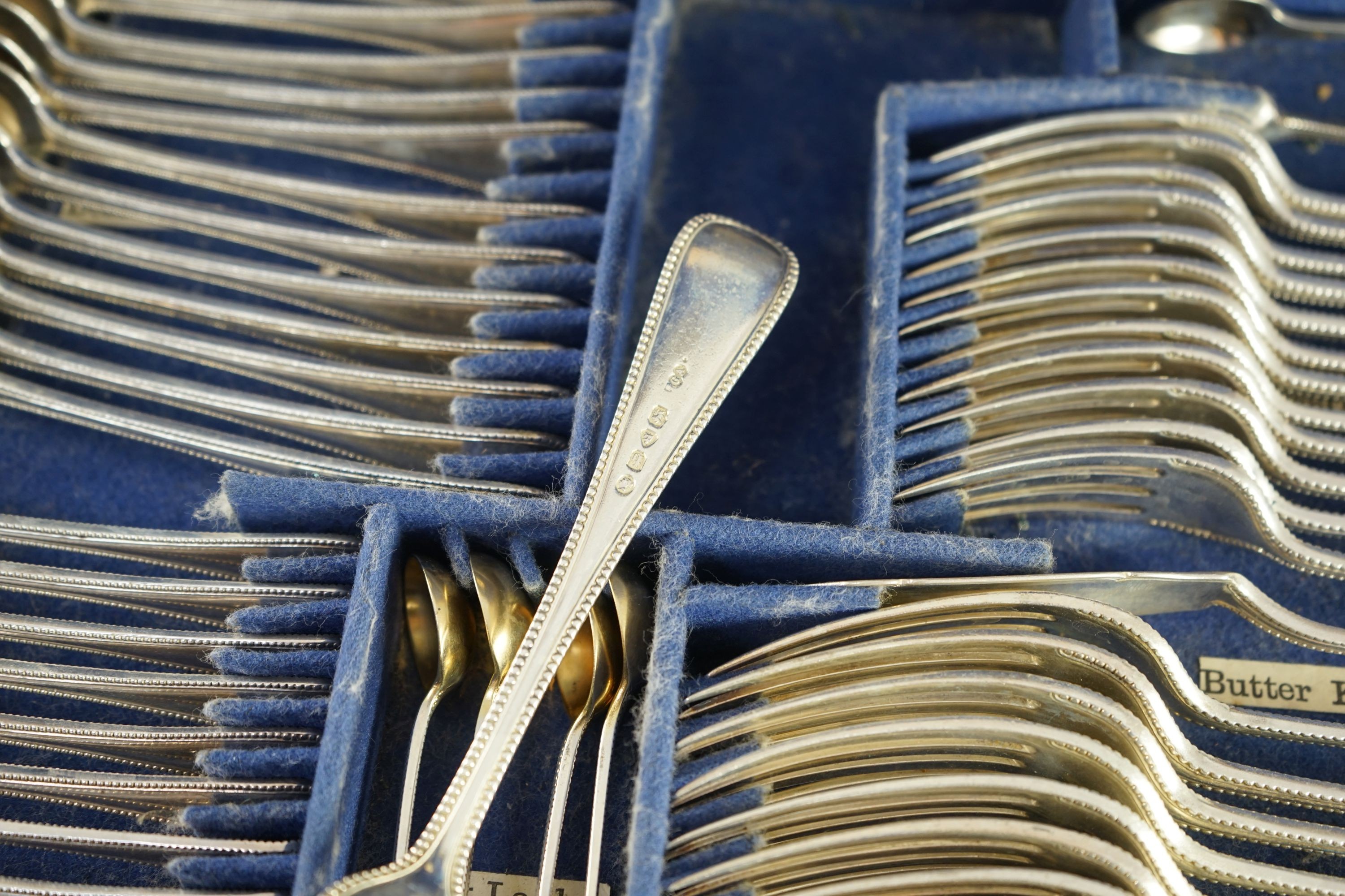 A Victorian part canteen of silver double struck Old English beaded pattern cutlery by George Adams